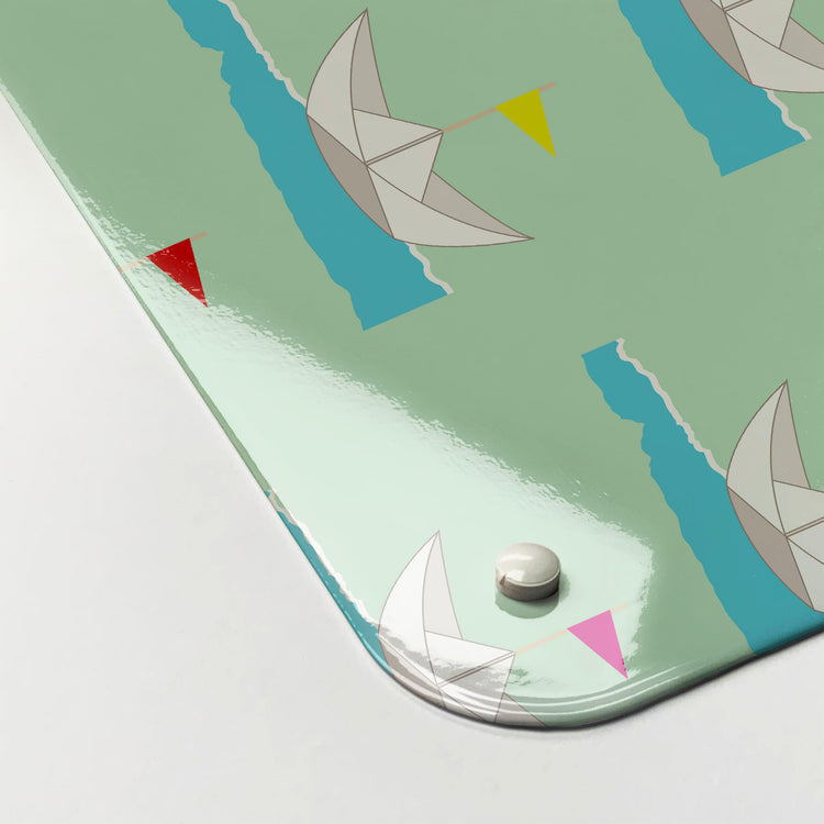 The corner detail of a paper boats design magnetic board to show it’s high gloss surface