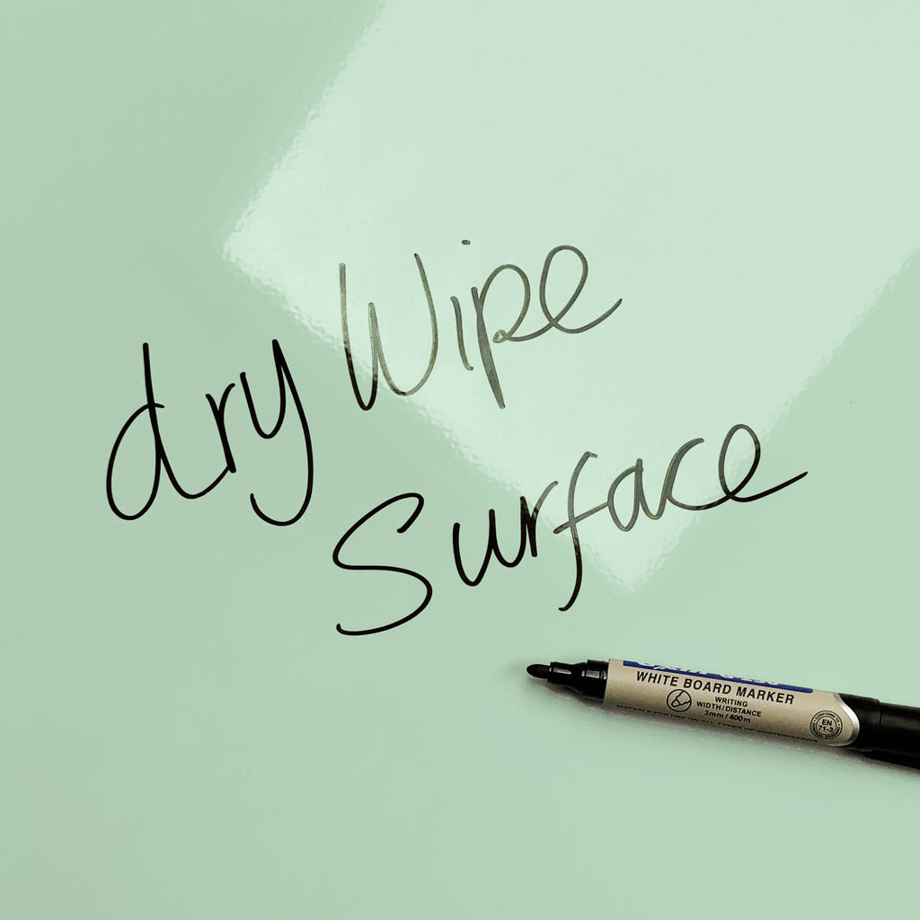 The words dry wipe surface written in marker pen on the Paper Boats Paper Boats magnetic notice board