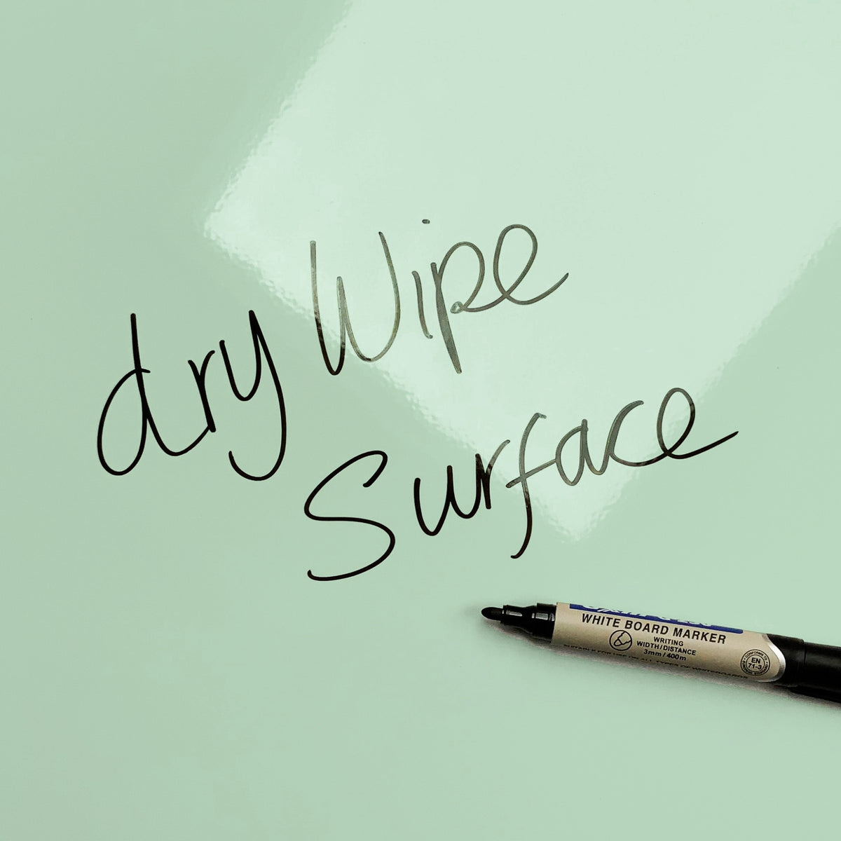 The words dry wipe surface written in marker pen on the Paper Boats Paper Boats magnetic notice board
