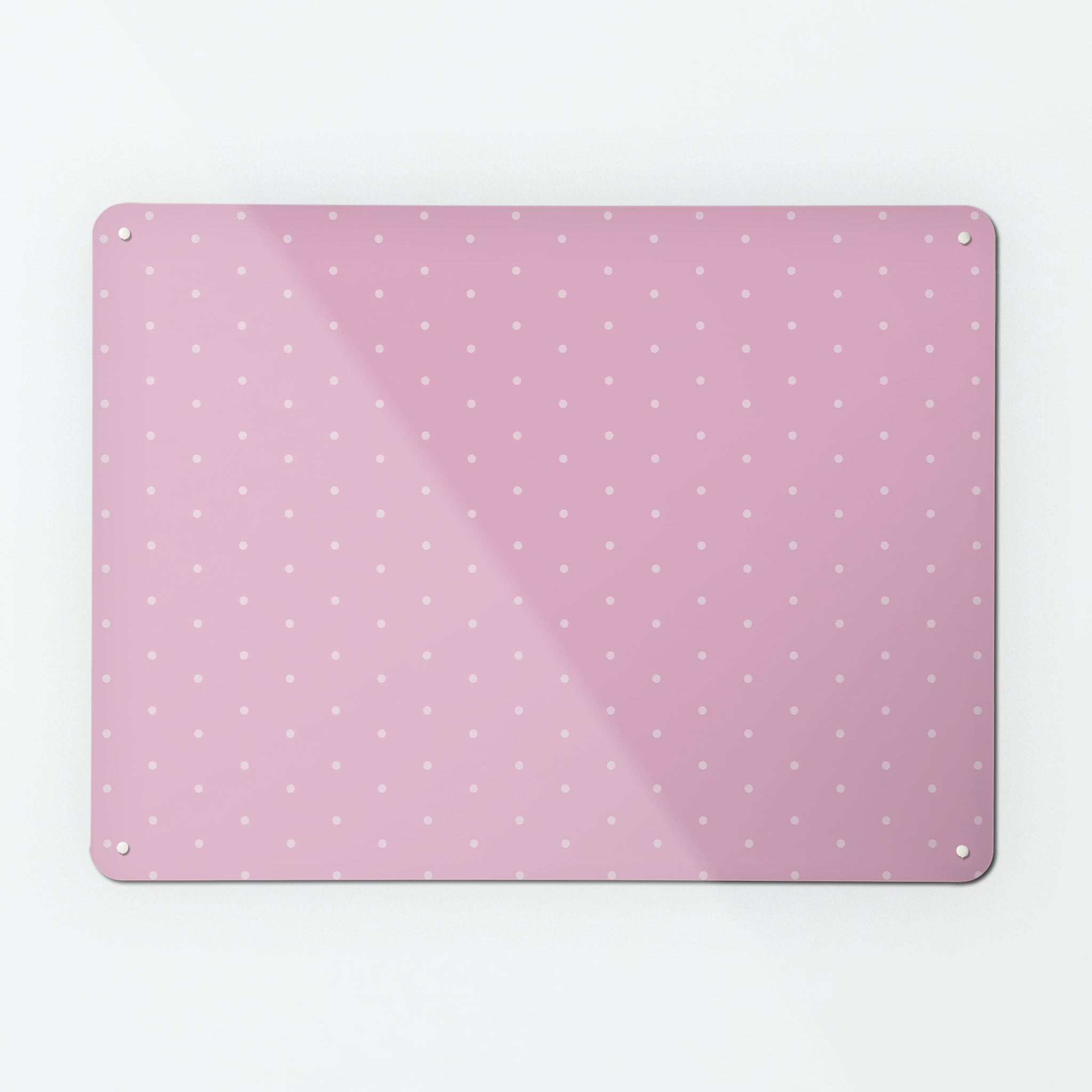 A large magnetic notice board by Beyond the Fridge with a pale pink polkadots on a pink background pattern