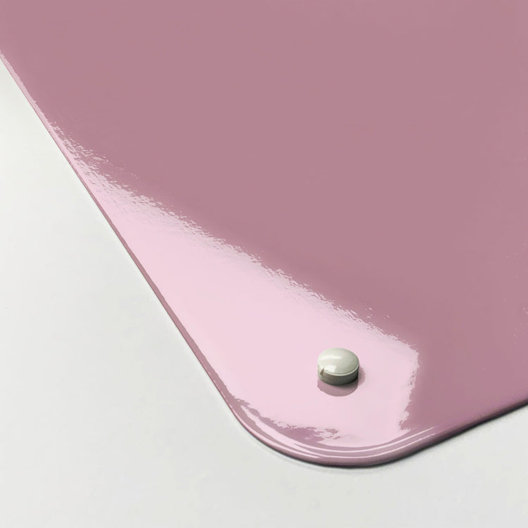 The corner detail of a plain pink magnetic board to show it’s high gloss surface