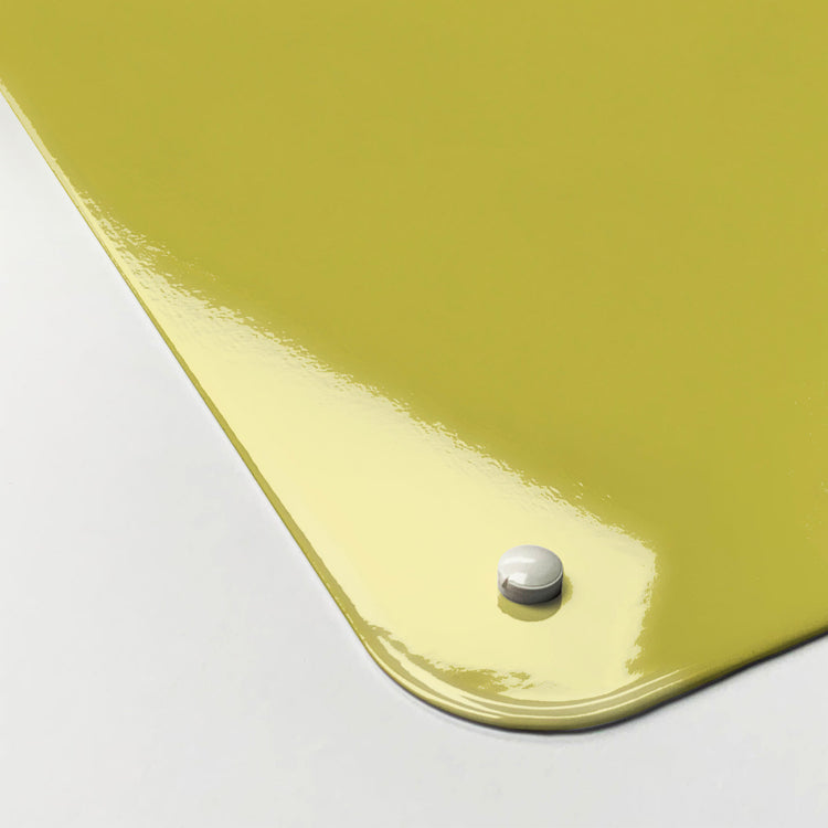 The corner detail of a plain yellow magnetic board to show it’s high gloss surface