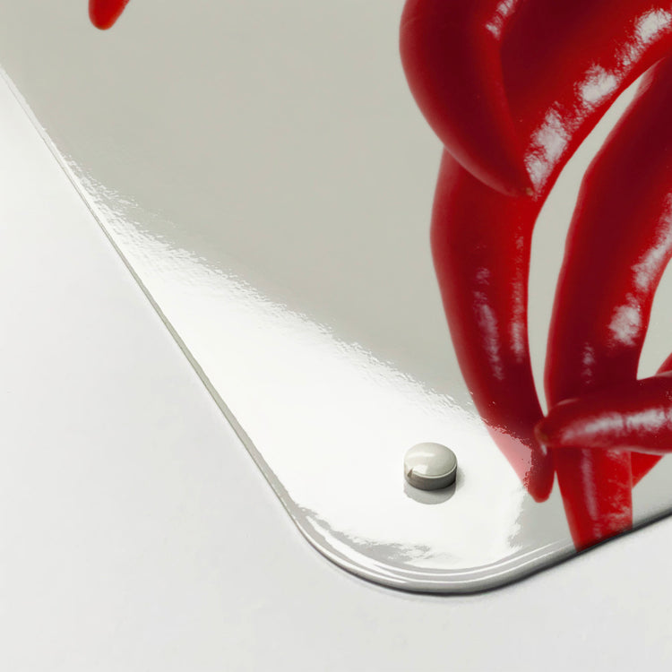 The corner detail of a red chillies photographic magnetic board to show it’s high gloss surface
