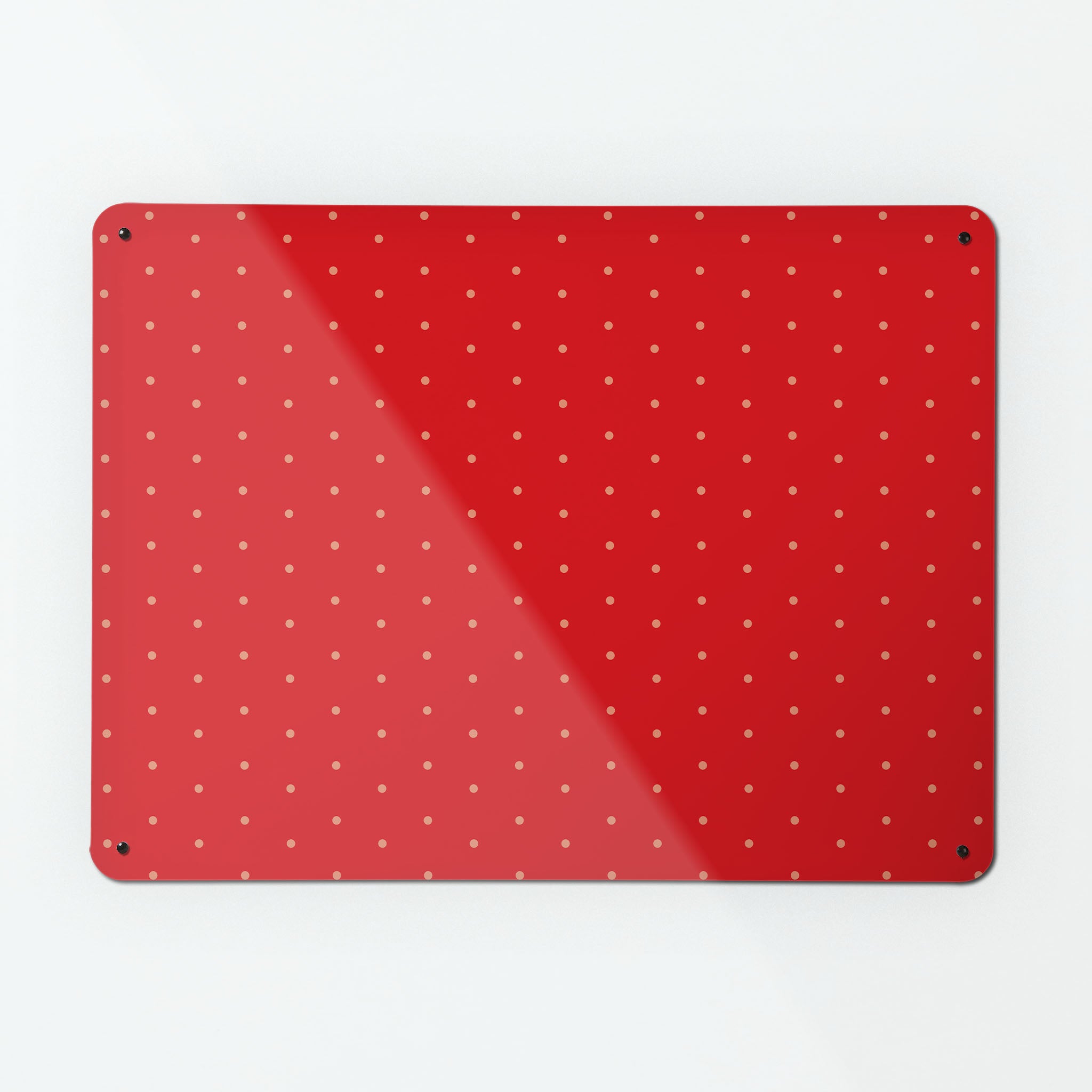 A large magnetic notice board by Beyond the Fridge with a pink polkadots on a red background pattern