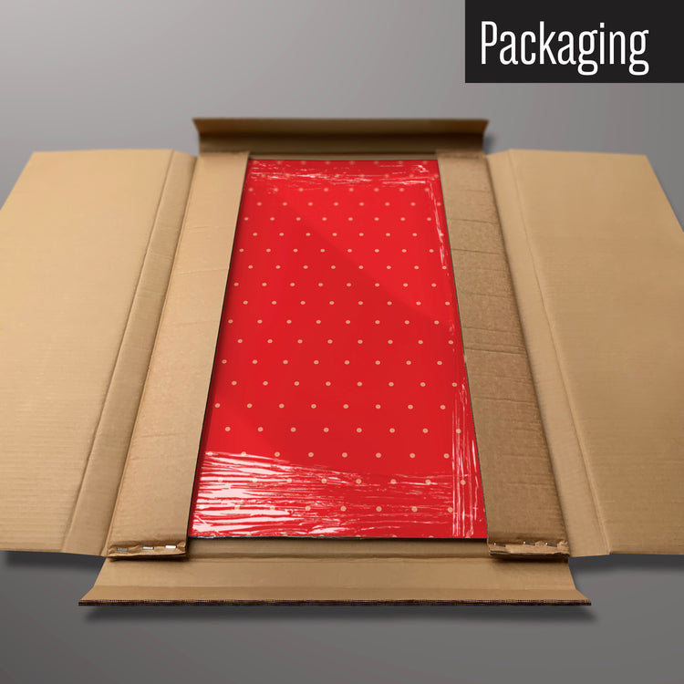 A red polkadot design magnetic board in it’s cardboard packaging