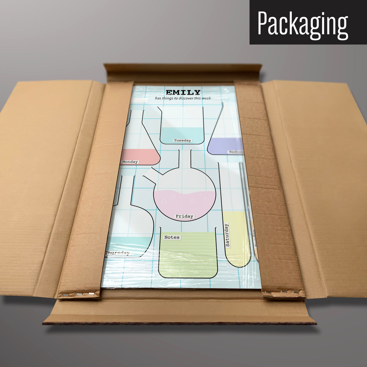 A science lab personalised dry wipe weekly planner magnetic board in it’s cardboard packaging