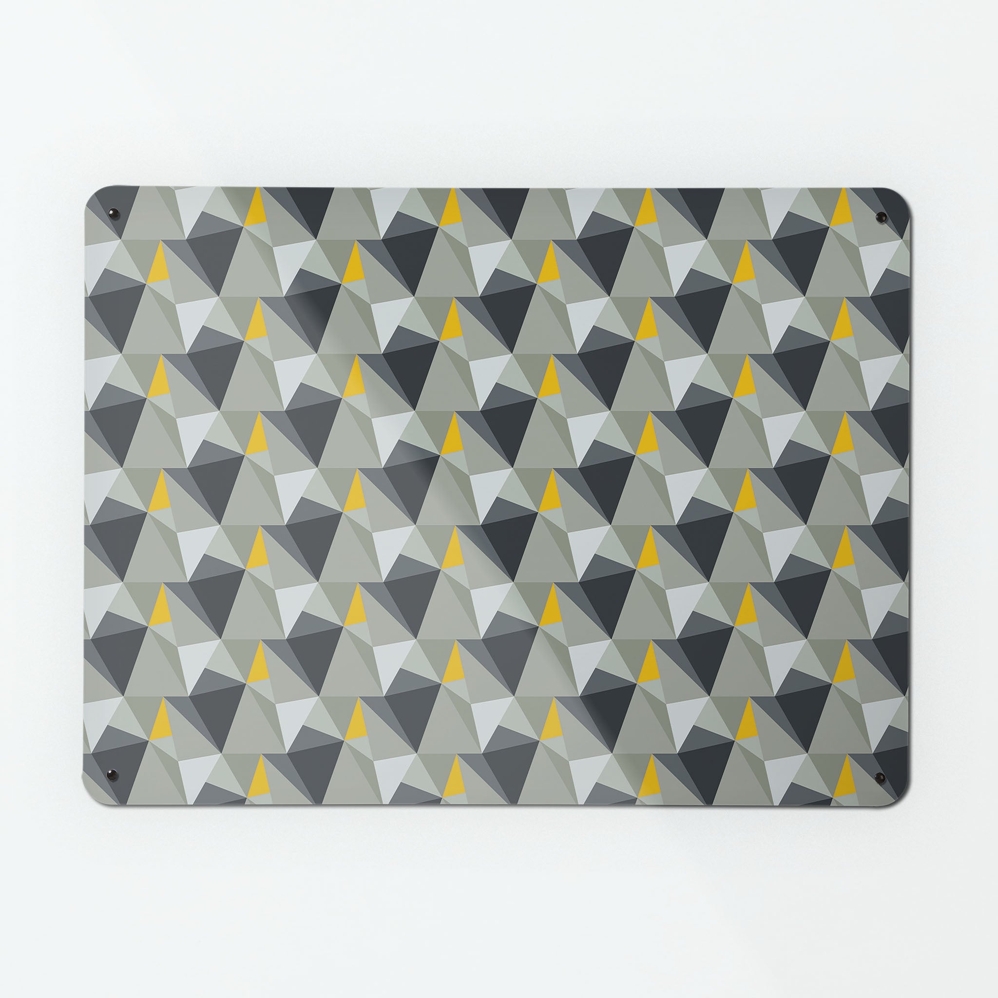A large magnetic notice board by Beyond the Fridge with a shards geometric design in grey and yellow colours