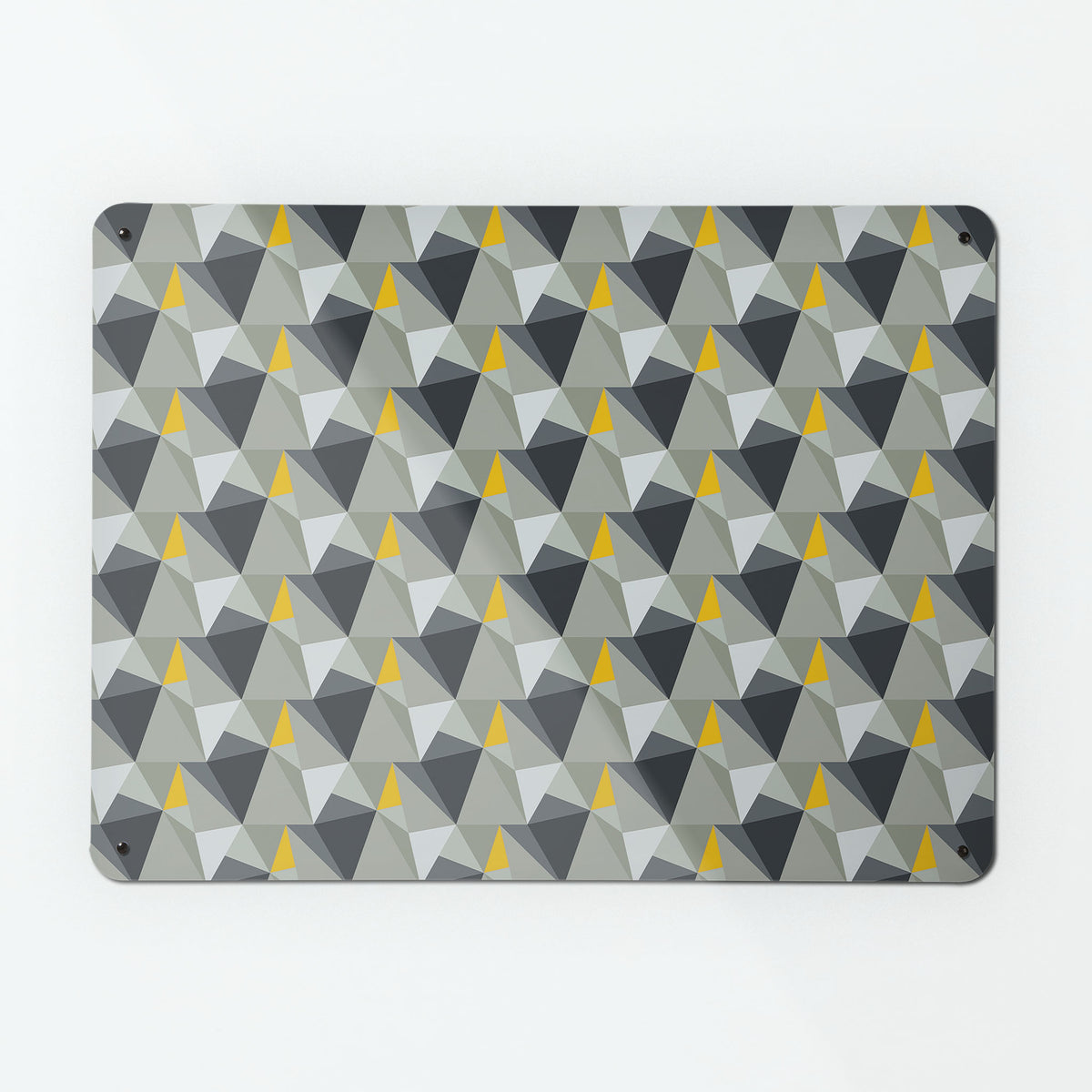 A large magnetic notice board by Beyond the Fridge with a shards geometric design in grey and yellow colours