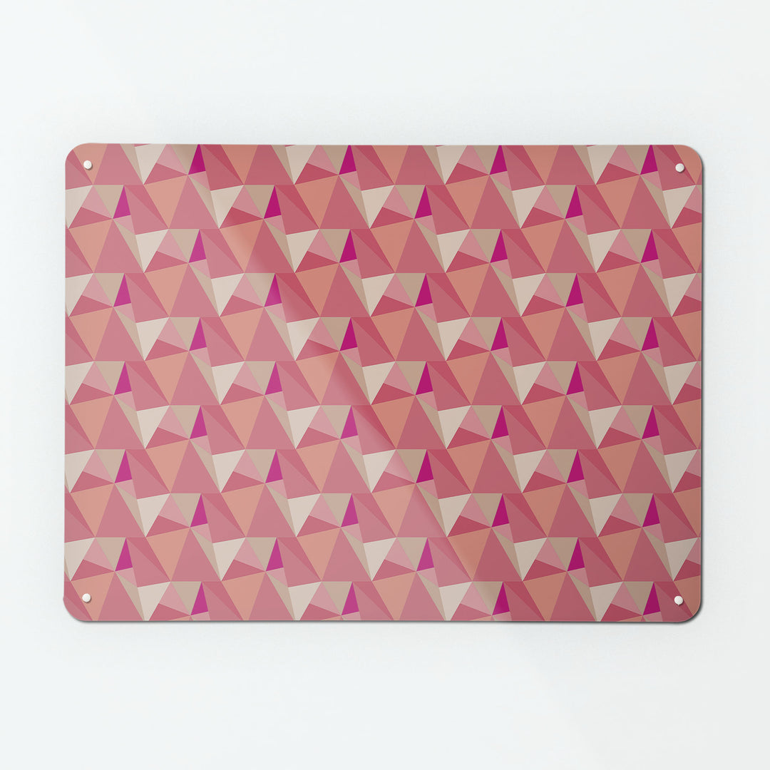 A large magnetic notice board by Beyond the Fridge with a shards geometric design in pink colours