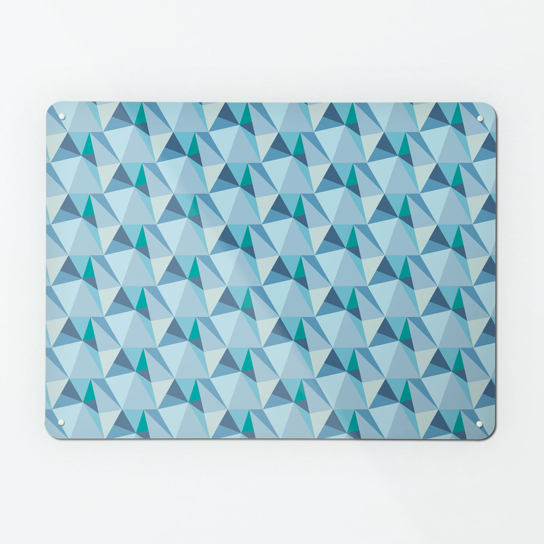 A large magnetic notice board by Beyond the Fridge with a shards geometric design in blue colours