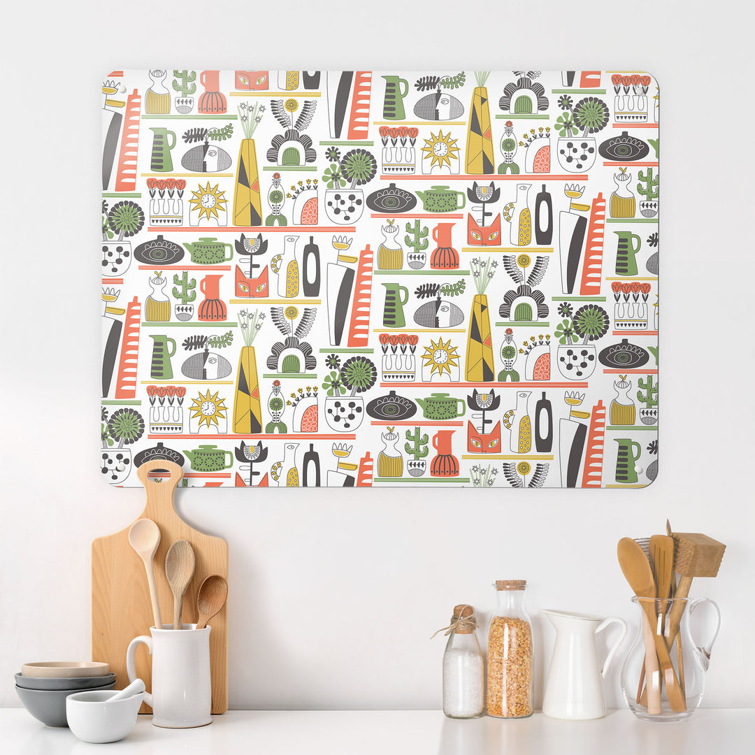 A kitchen interior with a magnetic metal wall art panel showing a shelf life pattern in warm colour tones