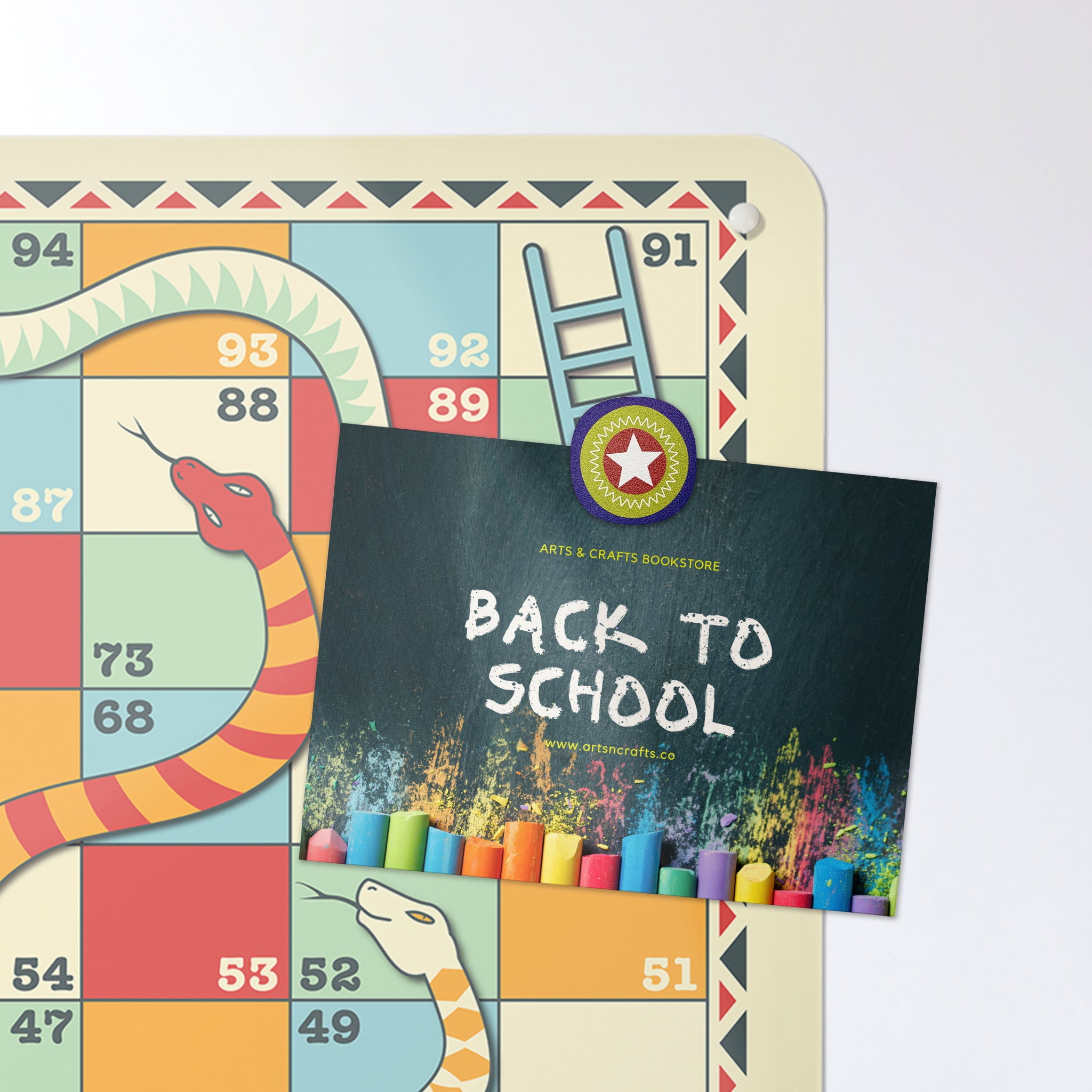 A postcard on a snakes and ladders game magnetic board or metal wall art panel