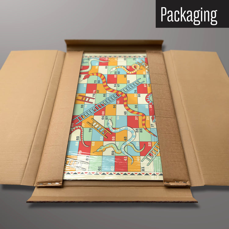 A snakes and ladders magnetic board in it’s cardboard packaging