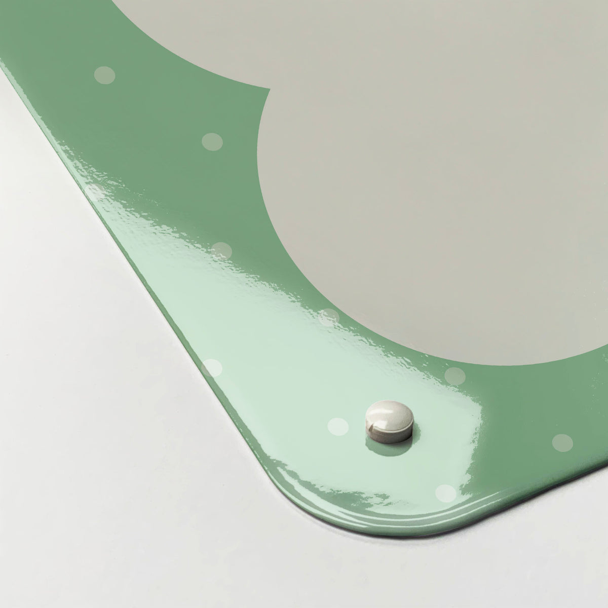 The corner detail of a so much to do green dry erase magnetic board to show it’s high gloss surface