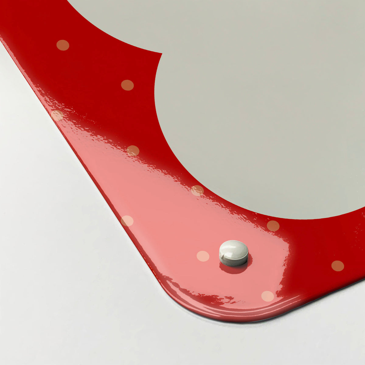 The corner detail of a so much to do red dry erase magnetic board to show it’s high gloss surface