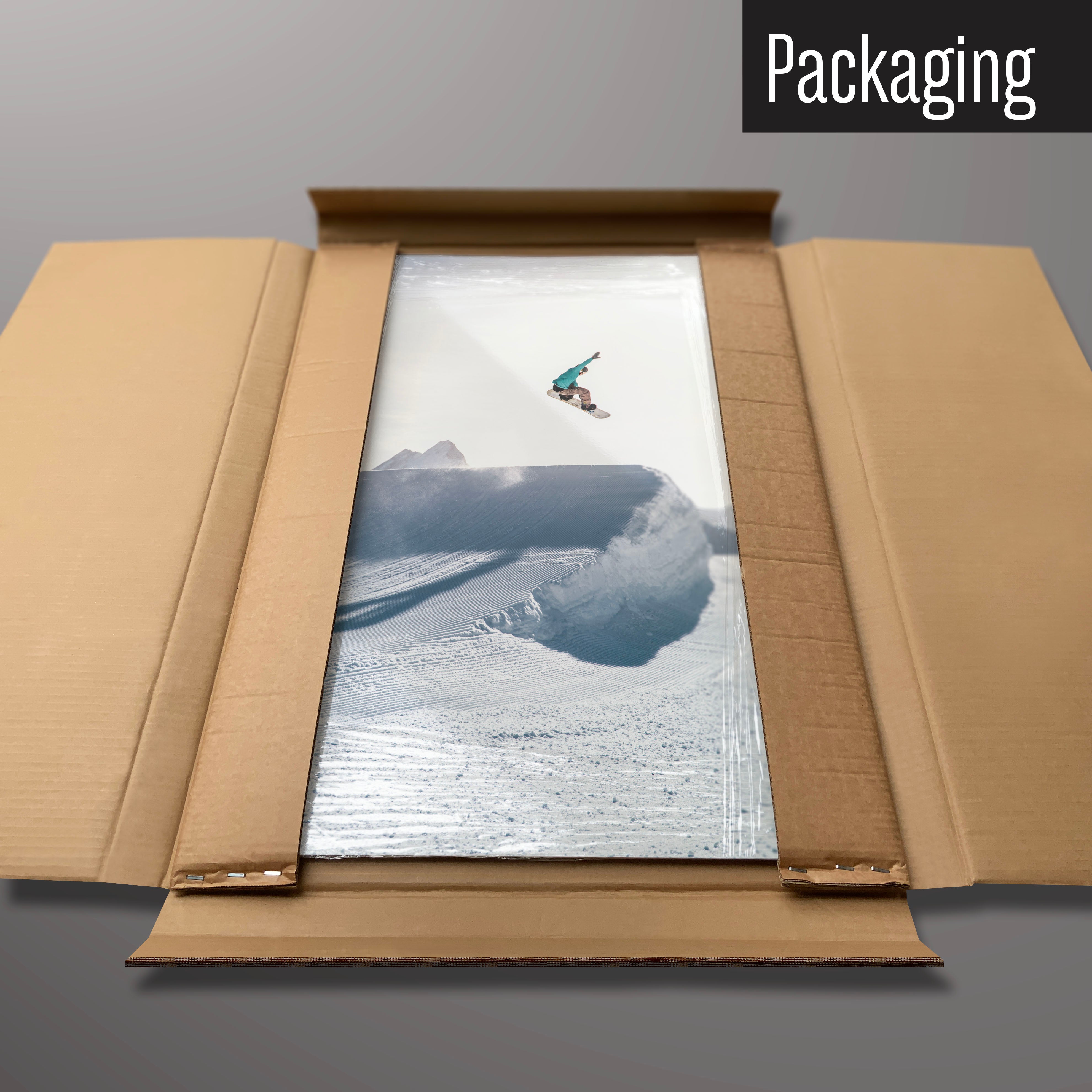 A snowboarding photographic magnetic board in it’s cardboard packaging
