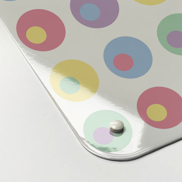 The corner detail of a spots design in pastel colours magnetic board to show it’s high gloss surface