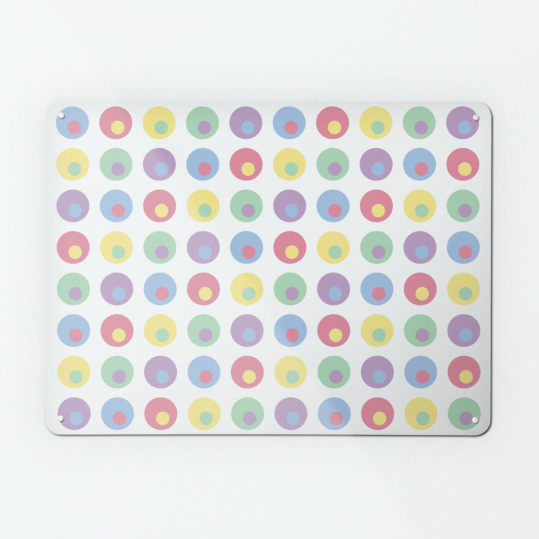A large magnetic notice board by Beyond the Fridge with a spots design in multi pastel colours on a white background