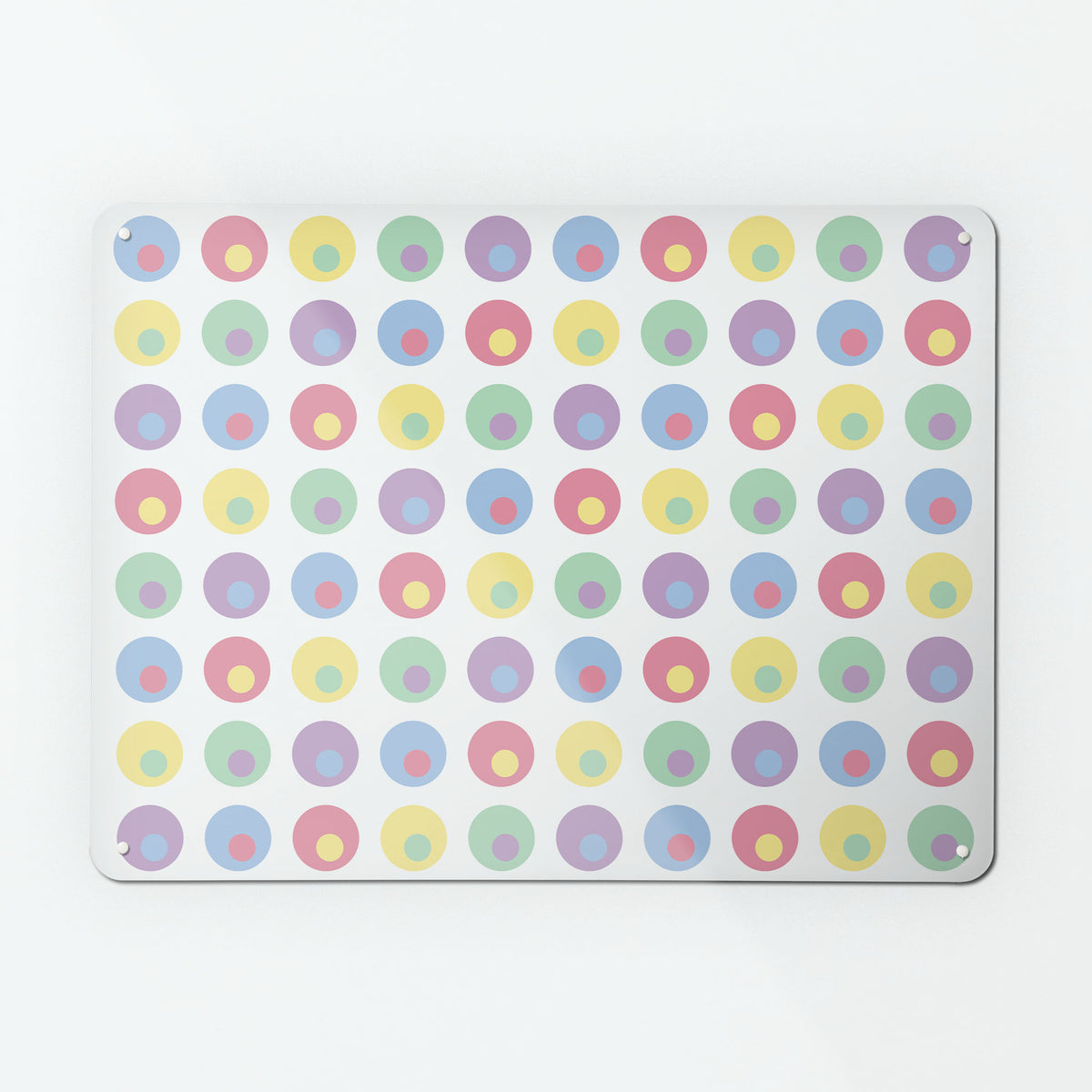 A large magnetic notice board by Beyond the Fridge with a spots design in multi pastel colours on a white background