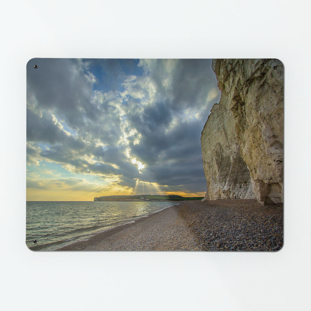 A large magnetic notice board by Beyond the Fridge with a photograph of cliffs and ocean at sunset on the Sussex Coast 