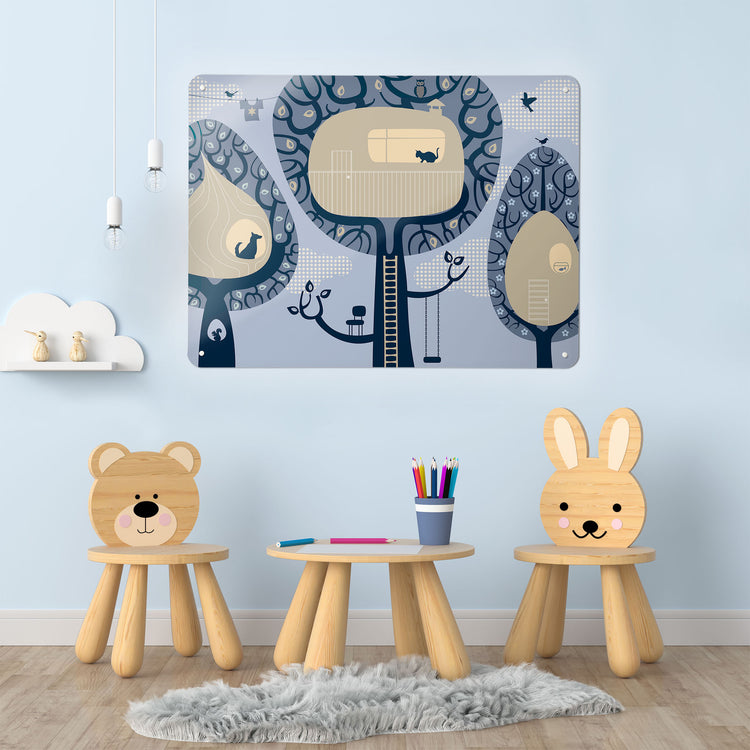 A playroom interior with a magnetic metal wall art panel showing a blue treehouses design