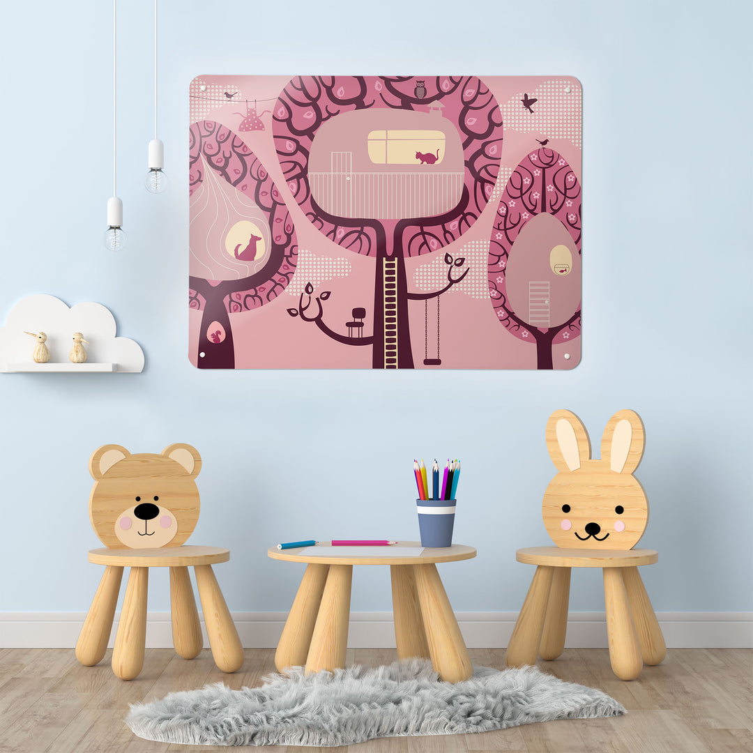 A playroom interior with a magnetic metal wall art panel showing a pink treehouses design