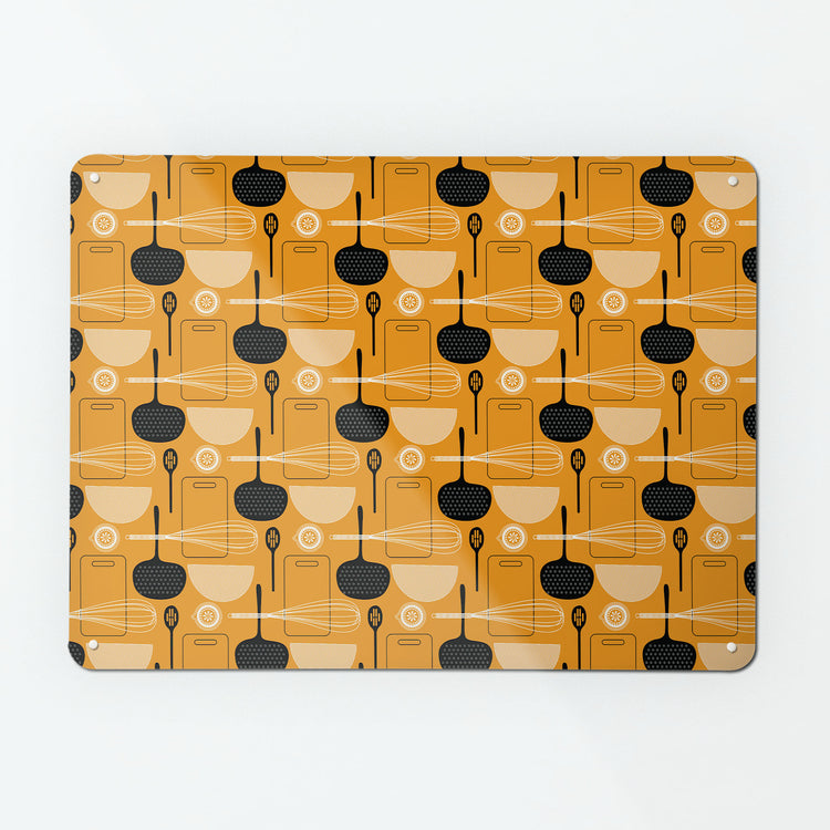 A large magnetic notice board by Beyond the Fridge with a utensils repeat pattern design in orange colour way
