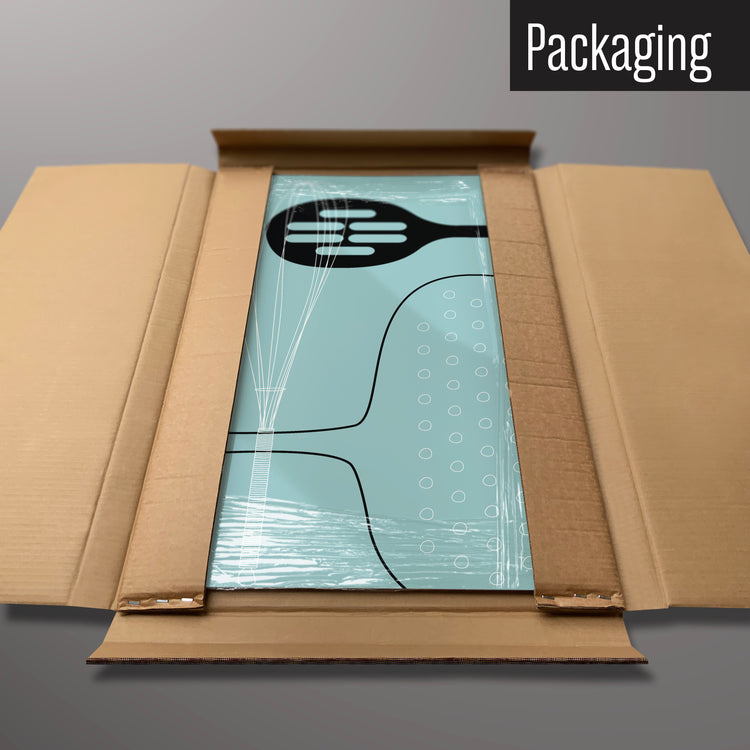 A blue utensils design magnetic board in it’s cardboard packaging