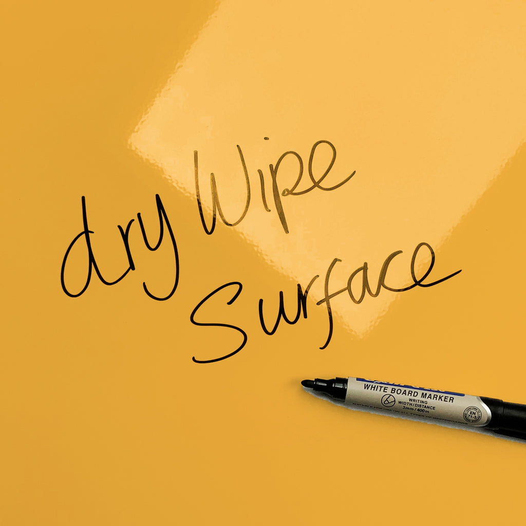 The words dry wipe surface written in marker pen on the 'Wise Owl - Times Tables' Wise Owl Times Tables magnetic notice board