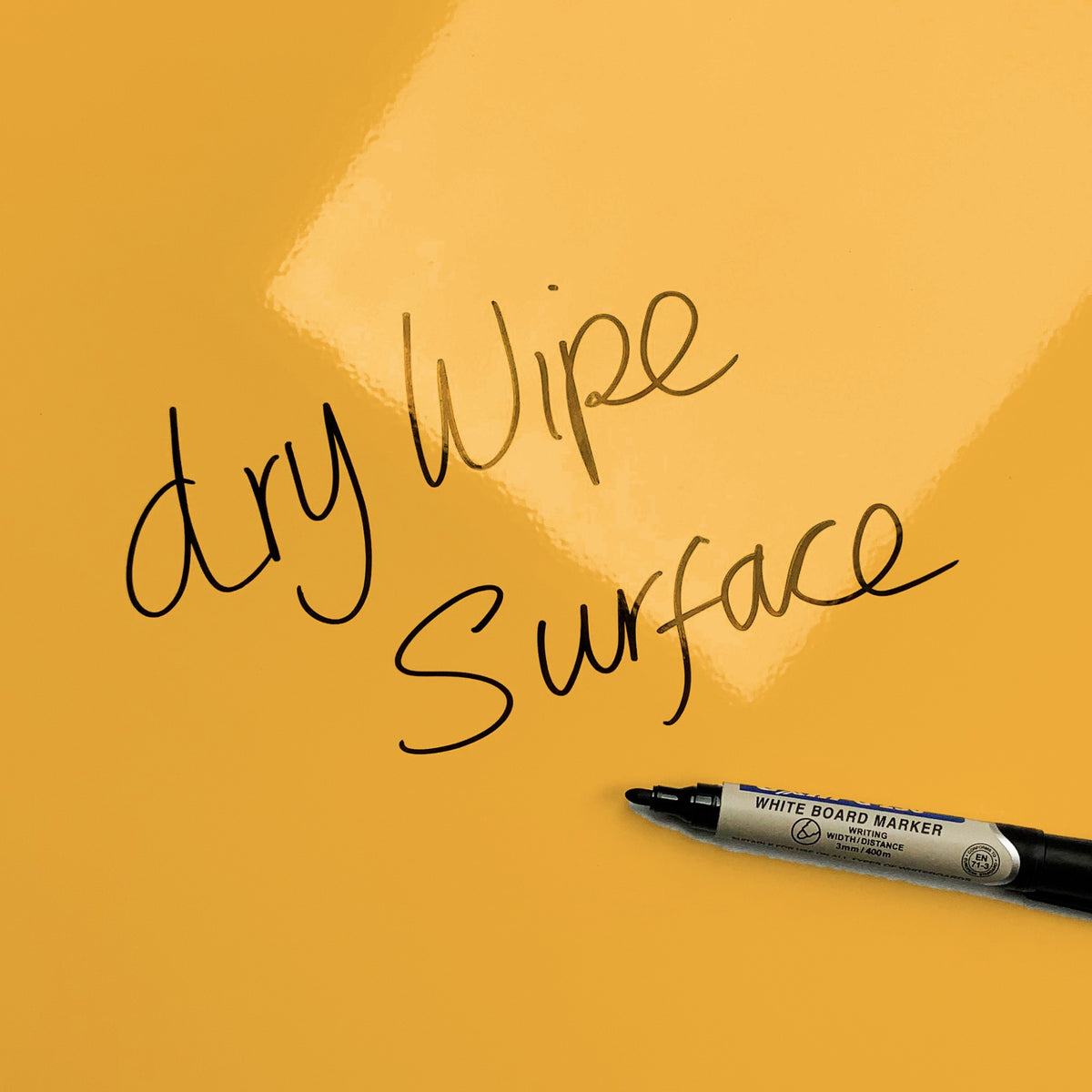 The words dry wipe surface written in marker pen on the 'Wise Owl - Times Tables' Wise Owl Times Tables magnetic notice board
