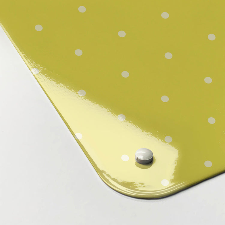The corner detail of a polkadots on yellow design magnetic board to show it’s high gloss surface