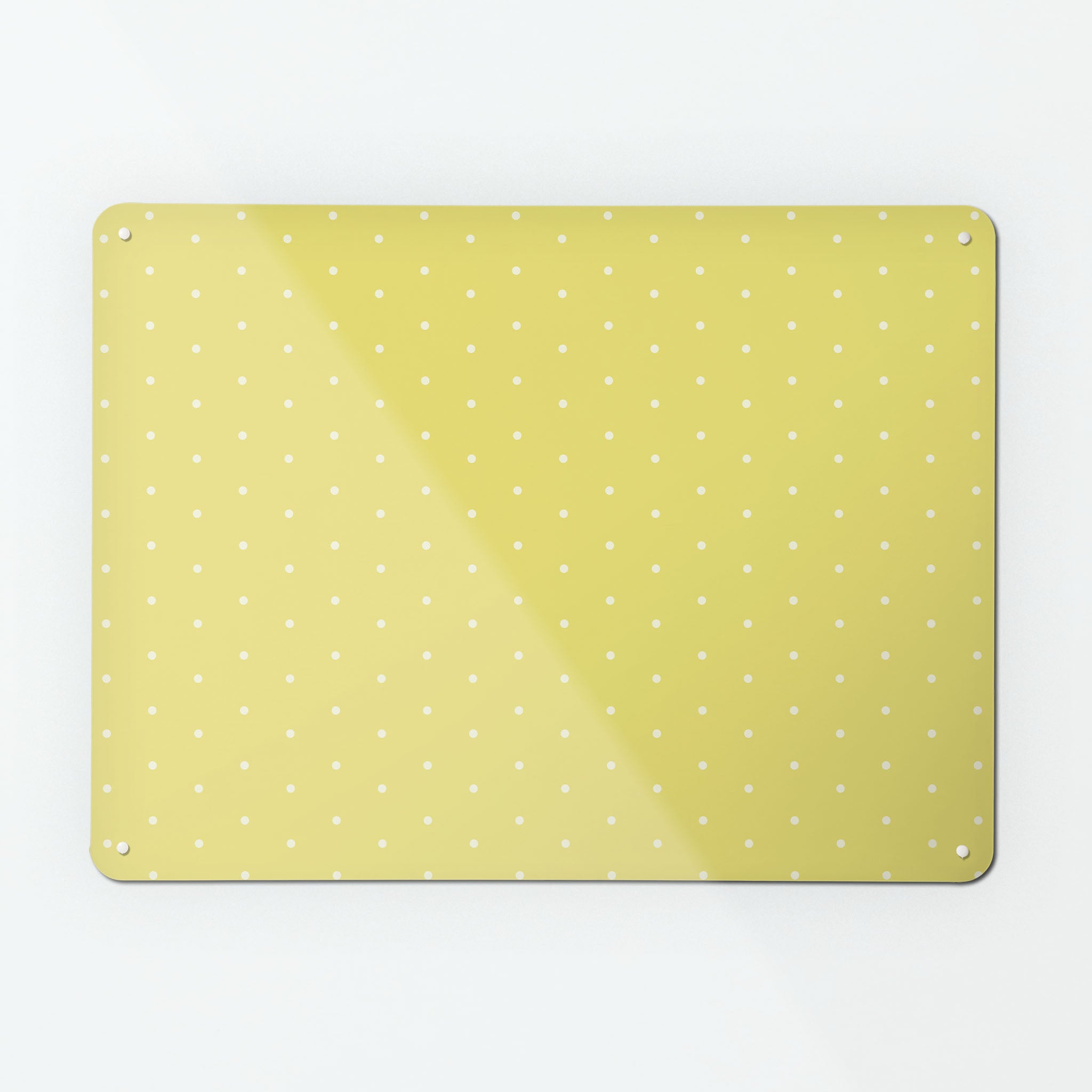 A large magnetic notice board by Beyond the Fridge with a white polkadots on a yellow background pattern