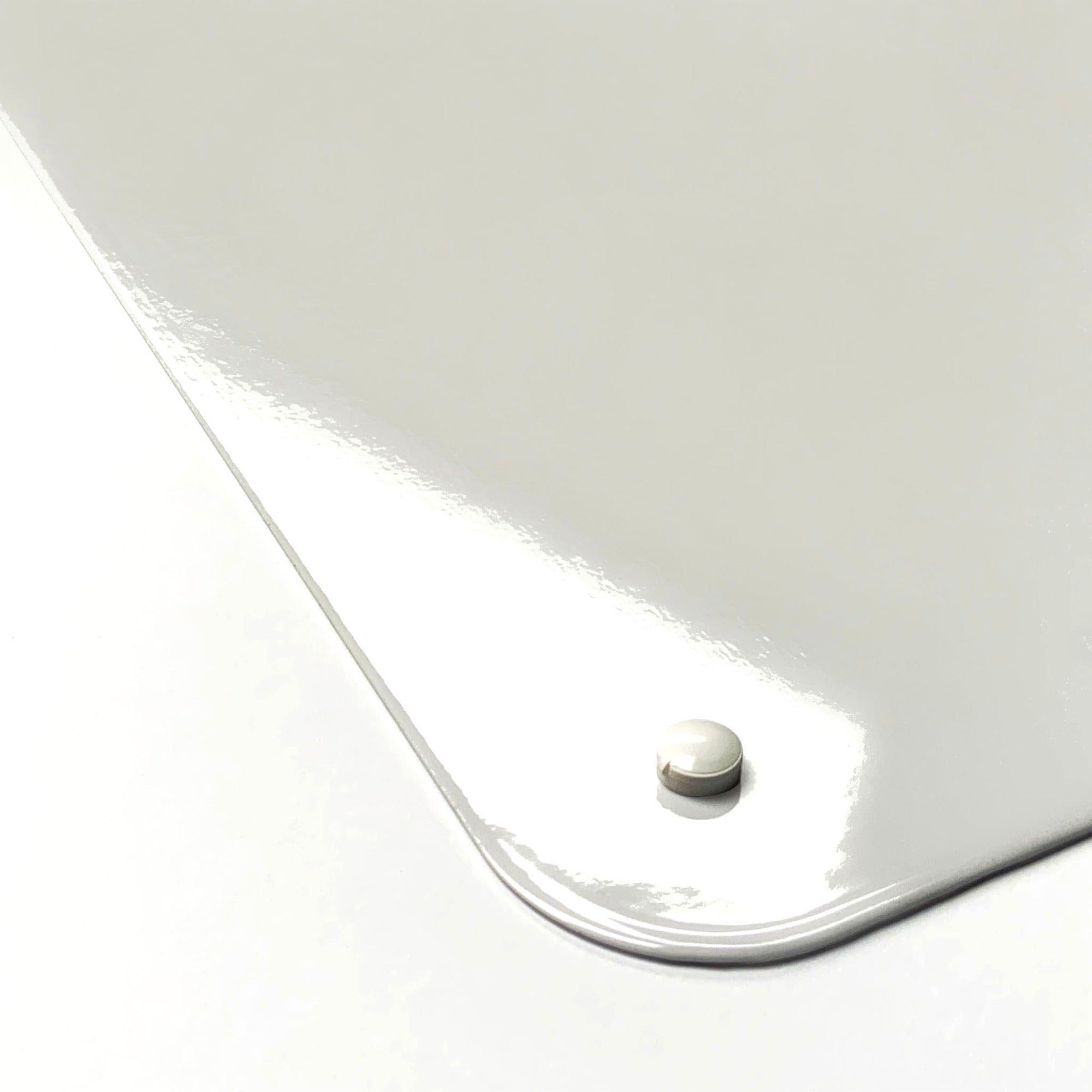 Rounded corner of a steel board with a magnet holding on the gloss surface