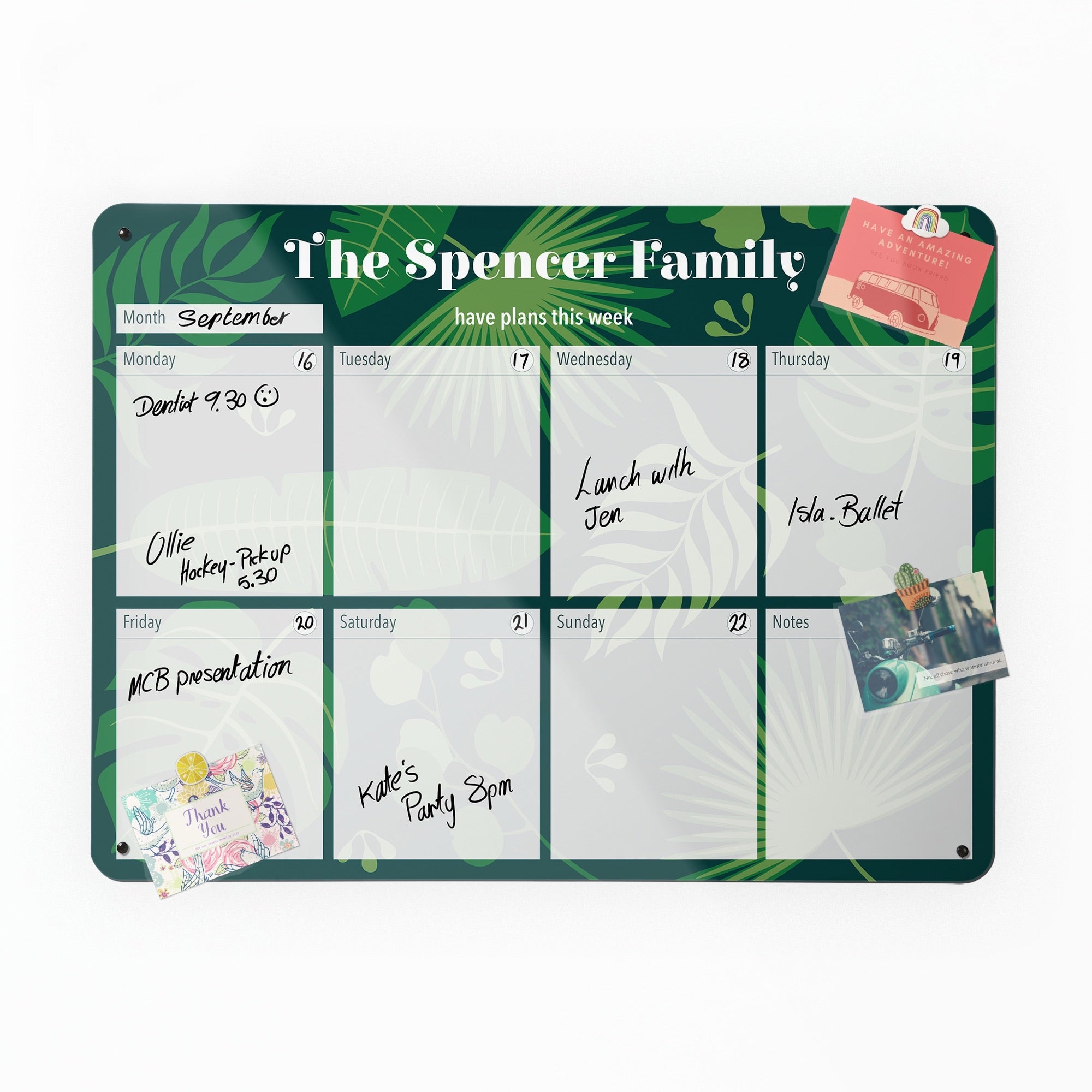 The Tropical leaves personalised weekly planner, filled in by hand with a postcard held on by a magnet