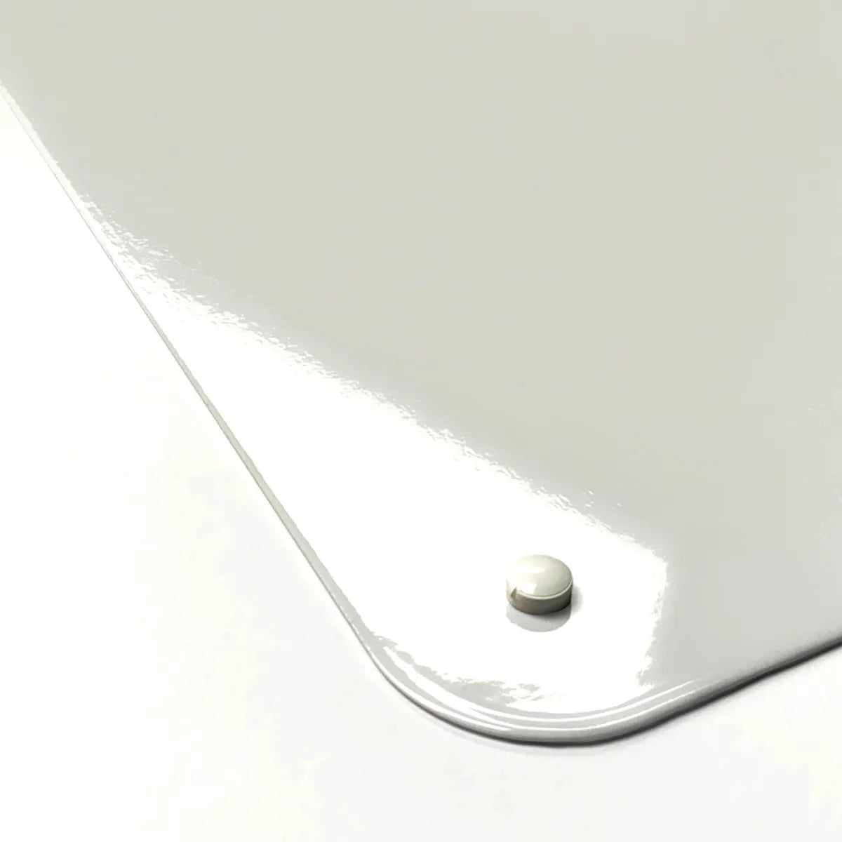 Rounded corner of a steel board with a magnet holding on the gloss surface