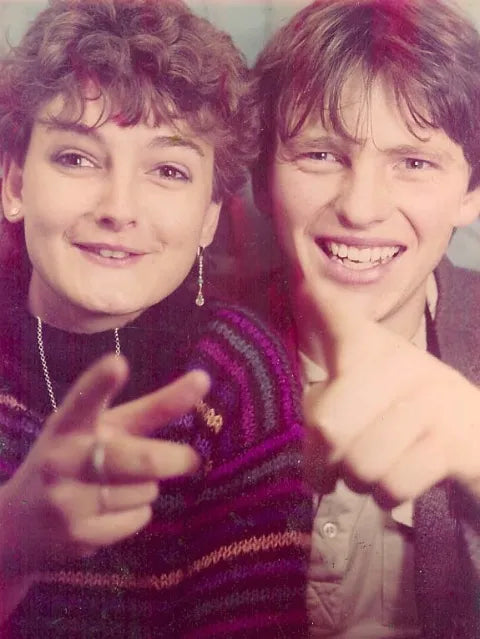 Duncan and Amanda in the 1980s, both pointing at the camera and laughing