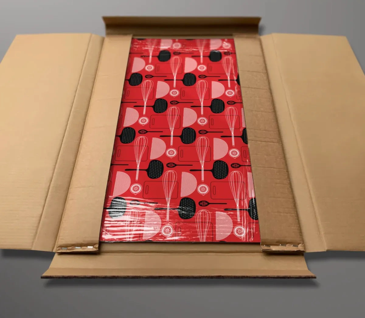 A finished red utensil-print panel wrapped and boxed with corner protection