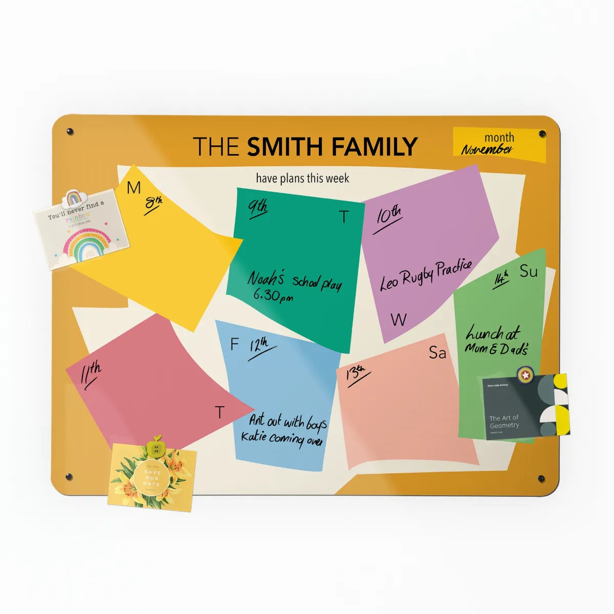 The Paper cut personalised weekly planner, filled in by hand with a postcard held on by a magnet
